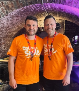 Danny and Dan smiling to camera after running the Great Manchester Run 2023